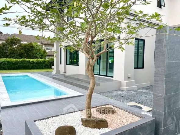 Modern home exterior with sleek pool and landscaped garden