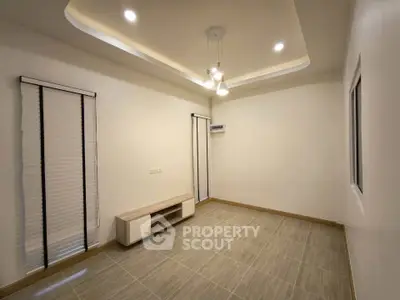 Spacious modern living room with elegant lighting and minimalist design.