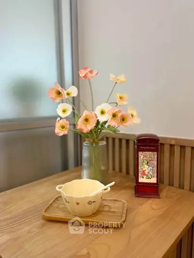 Charming interior with elegant wooden table, decorative flowers, and vintage accents for a cozy ambiance.
