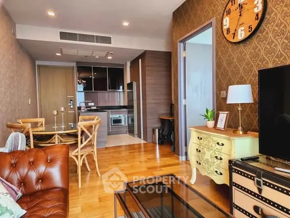 Chic living room with vintage decor and modern kitchen in open layout apartment.