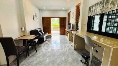 Spacious living room with modern decor and large windows offering natural light.