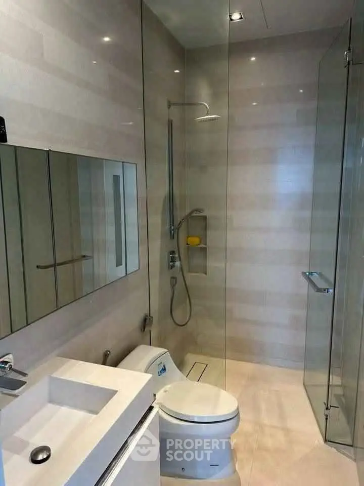 Modern bathroom with glass shower and sleek fixtures