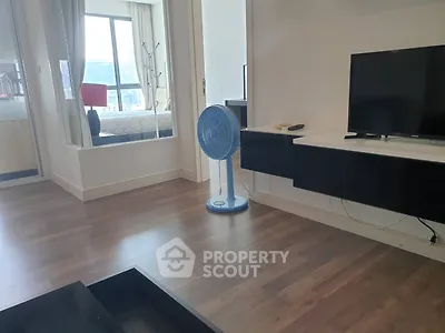 Modern living room with sleek TV stand and large window view