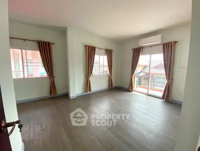 Spacious empty room with large windows and balcony access, perfect for customization.