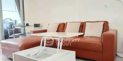 Modern living room with stylish brown leather sofa and white coffee table