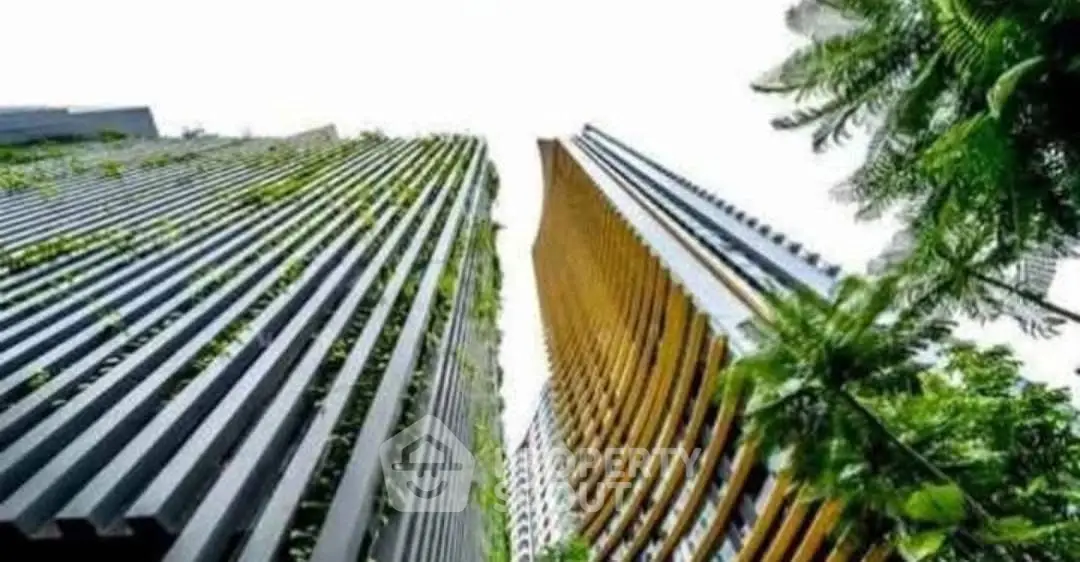 Stunning modern high-rise buildings with lush greenery and unique architectural design.