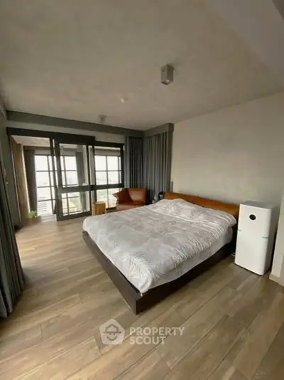 Spacious modern bedroom with large windows and stylish decor
