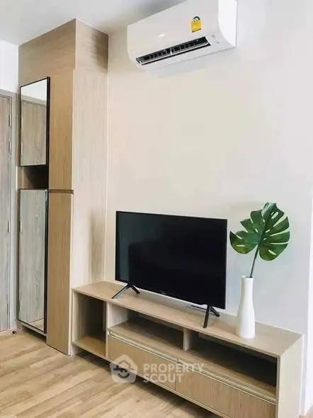 Modern living room with sleek TV unit and air conditioning