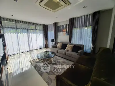 Spacious living room with elegant decor and large windows for natural light