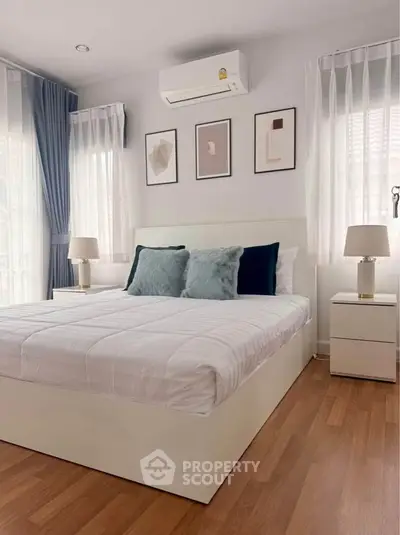 Cozy bedroom with modern decor and natural light, featuring a comfortable bed and stylish furnishings.