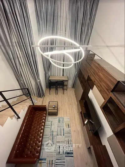 Modern loft-style living room with high ceilings and stylish lighting