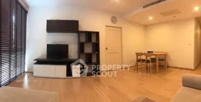 Spacious modern living room with wooden flooring and stylish furniture