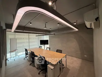 Modern office space with sleek lighting and large conference table