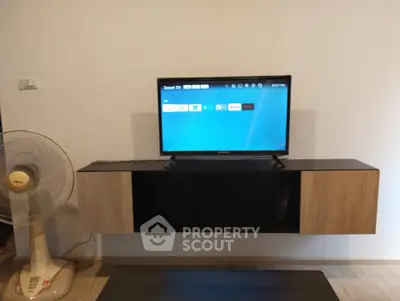 Modern living room with wall-mounted TV and sleek storage unit