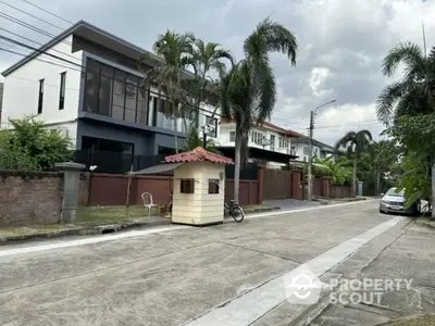 Charming residential street with modern houses and lush greenery, perfect for serene living.