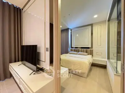 Modern bedroom with sleek design and large TV, featuring elegant decor and ample natural light.