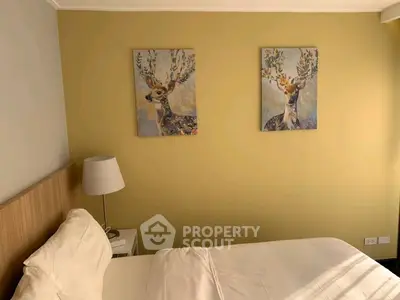 Cozy bedroom with stylish deer artwork and soft lighting