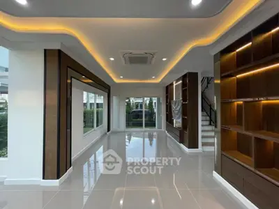Spacious modern living room with elegant lighting and built-in shelves