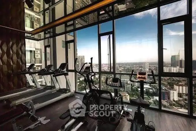 Luxurious high-rise gym with panoramic city views and modern fitness equipment.