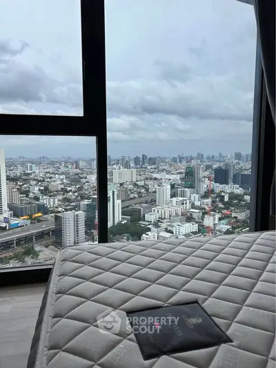Stunning cityscape view from a high-rise apartment with large windows and modern interior.