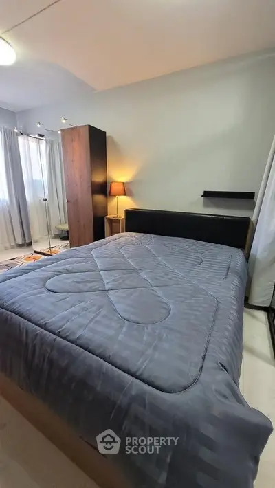 Cozy bedroom with modern decor and ample natural light