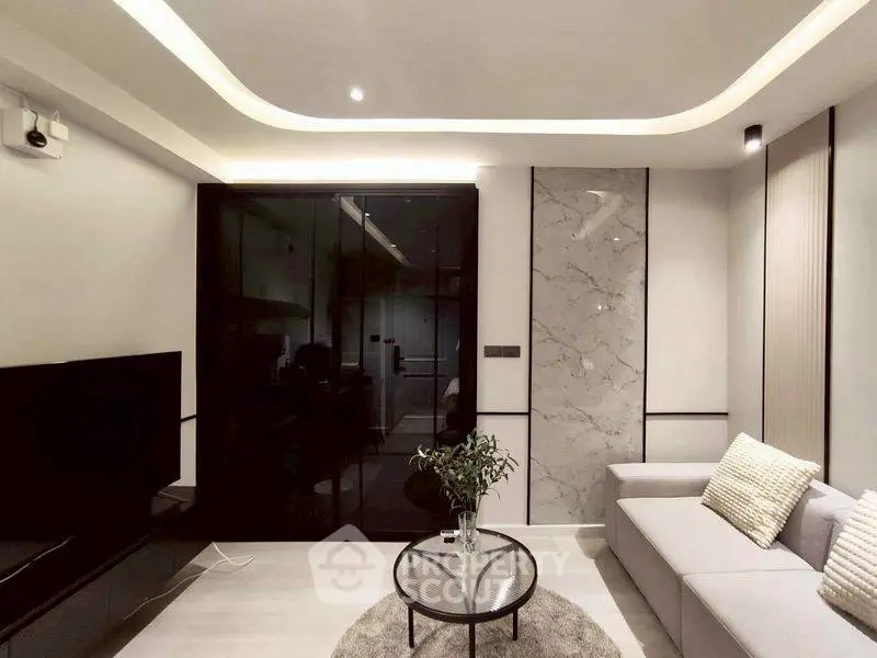 Modern living room with sleek design and elegant lighting