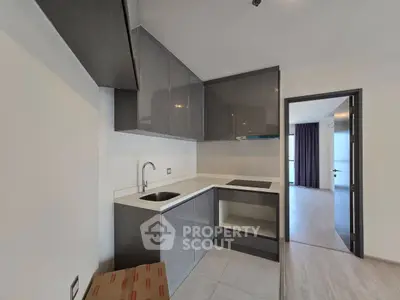 Modern kitchen with sleek cabinetry and open layout in a stylish apartment.