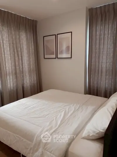 Cozy bedroom with modern decor and soft lighting, perfect for relaxation.