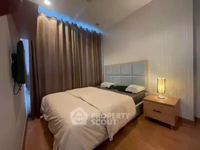 Cozy bedroom with modern decor and soft lighting, perfect for relaxation and comfort.