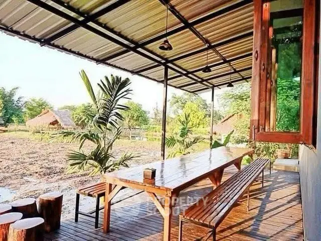 Charming outdoor patio with rustic wooden furniture and lush greenery, perfect for relaxation and entertaining.