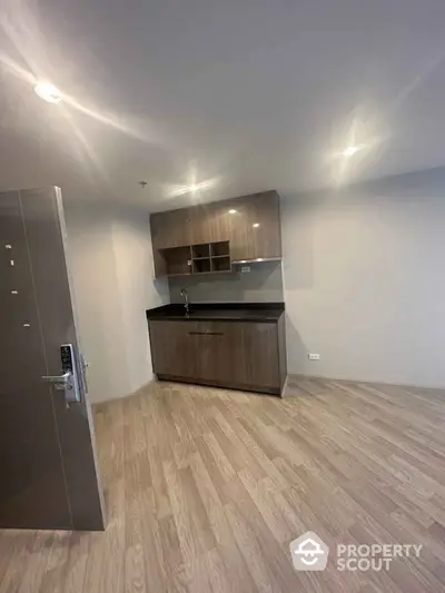 Modern minimalist kitchen with sleek cabinets and wood flooring