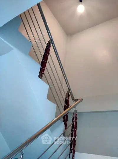 Modern staircase with sleek metal railing in a contemporary building