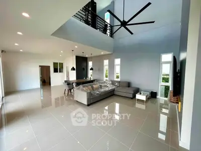 Spacious modern living room with high ceiling and sleek design