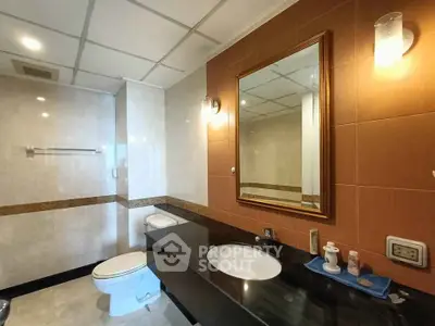 Spacious modern bathroom with elegant fixtures and large mirror