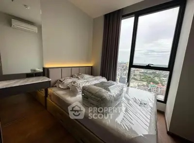 Modern bedroom with large window offering city view and stylish decor