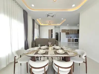 Elegant open-plan dining and living area with modern decor and stylish furniture