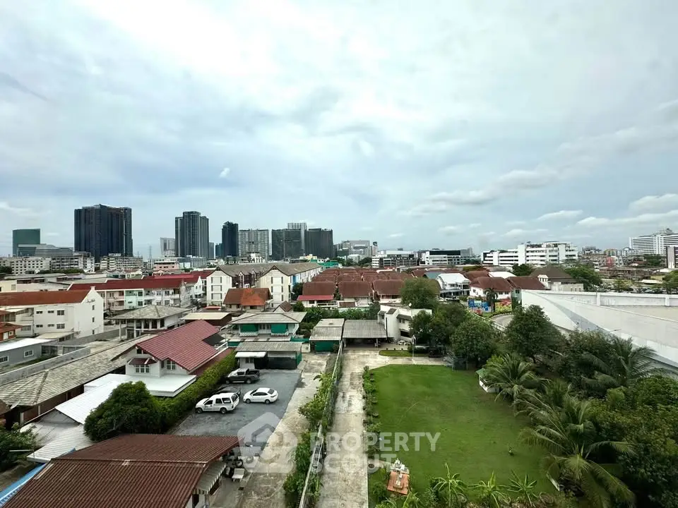 Stunning cityscape view showcasing a blend of urban skyline and residential area with lush greenery.