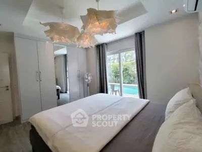Luxurious bedroom with pool view and modern lighting