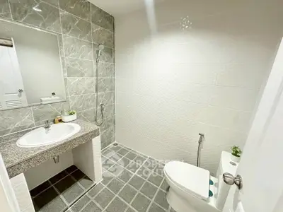Modern bathroom with elegant gray tiles and sleek fixtures