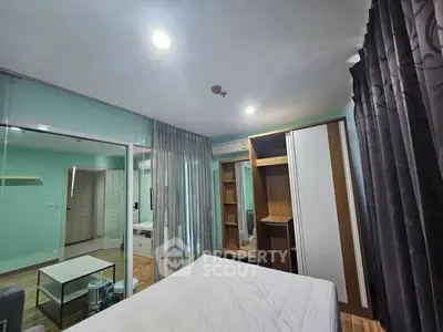 Spacious bedroom with mirrored closet and modern decor in a stylish apartment.