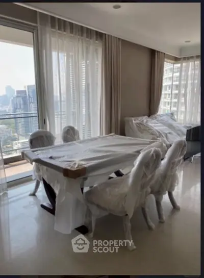 Spacious living room with city view and elegant dining set in modern apartment