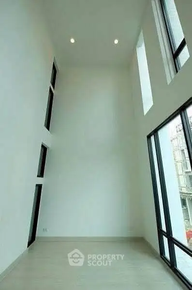 Spacious modern living room with high ceilings and large windows