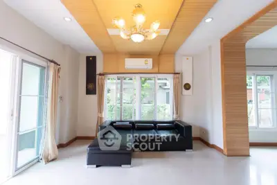 Spacious living room with modern black sofa and elegant lighting