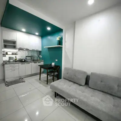 Modern open-layout kitchen and living room with sleek design and cozy seating area.