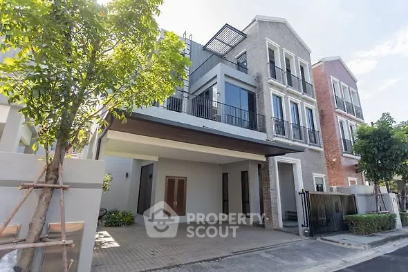 Modern townhouse exterior with spacious driveway and lush greenery