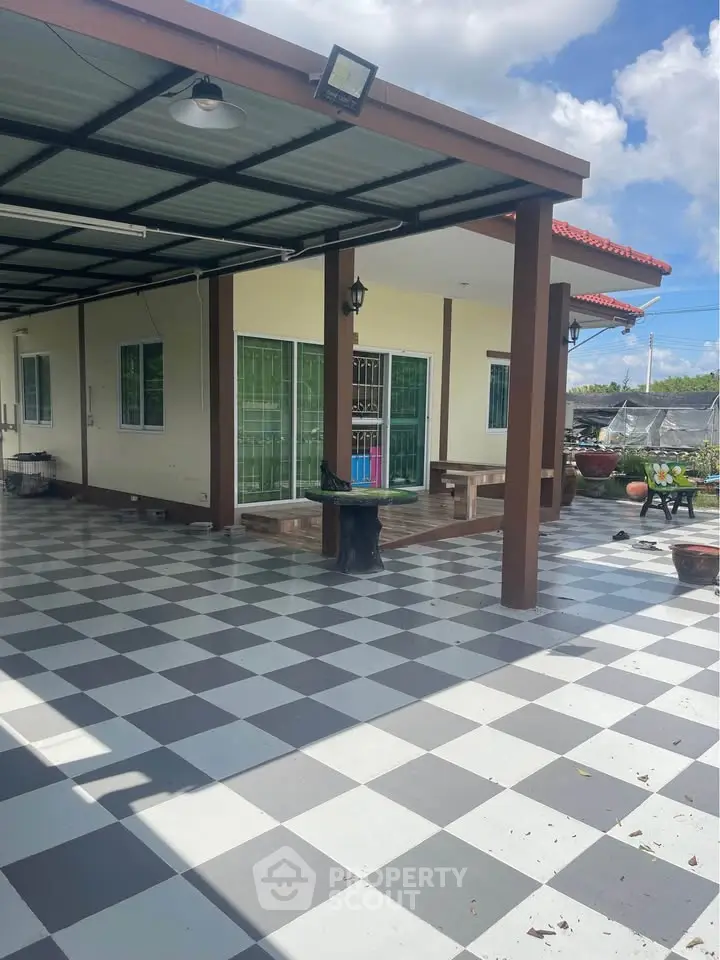 Charming single-story home with spacious tiled patio and covered outdoor area, perfect for relaxation and gatherings.