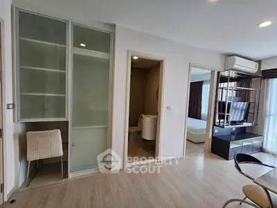 Modern apartment interior with open living space and bedroom view