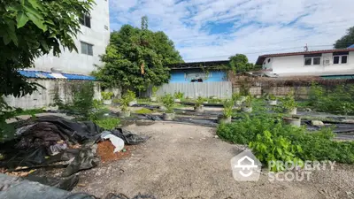 Spacious urban garden area with potential for development, featuring lush greenery and open space.