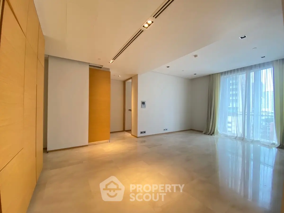 Spacious modern living room with large windows and elegant wooden accents