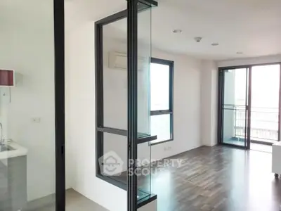Modern apartment interior with large windows and wooden flooring